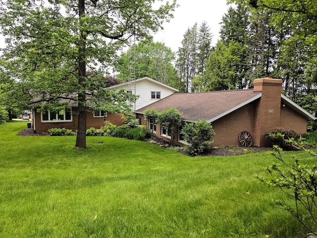 5344 Ridge Ave SE, Canton, OH 44707 - view of side of property featuring a yard, a chimney, and roof with shingles