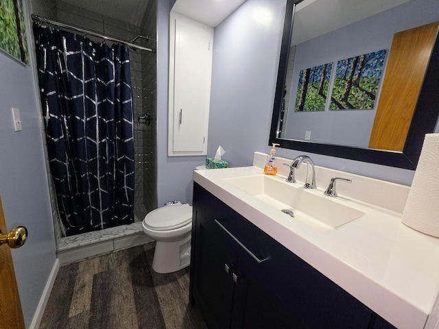 5344 Ridge Ave SE, Canton, OH 44707 - full bathroom with wood finished floors, toilet, vanity, and a tile shower