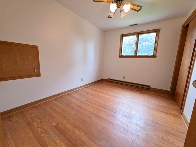 5344 Ridge Ave SE, Canton, OH 44707 - unfurnished bedroom with a baseboard heating unit, light wood finished floors, baseboards, and a ceiling fan