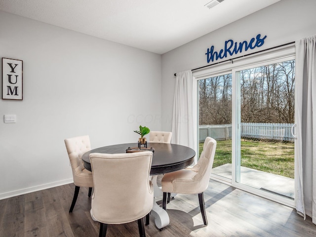 dining area featuring baseboards and wood finished floors