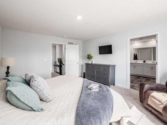 bedroom featuring baseboards, carpet flooring, connected bathroom, and visible vents
