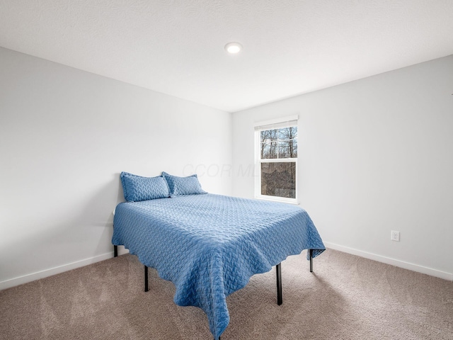 bedroom with baseboards and carpet flooring