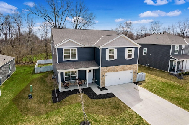 traditional home featuring concrete driveway, stone siding, a front lawn, a garage, and a shingled roof