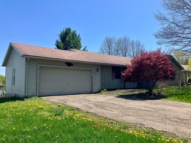 single story home featuring an attached garage and driveway
