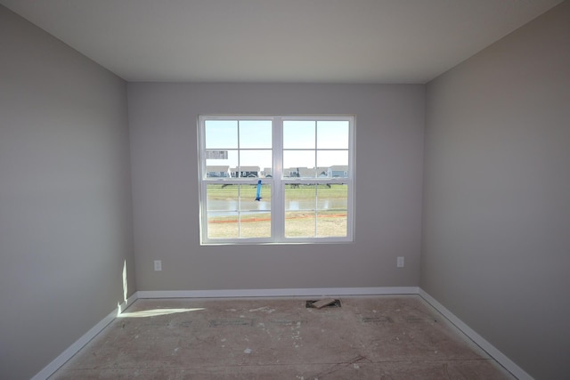 unfurnished room featuring baseboards
