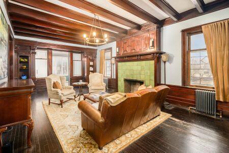 1349 E Broad St, Columbus, OH 43205 - living room with a wealth of natural light, wood finished floors, radiator heating unit, and beamed ceiling