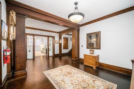 1349 E Broad St, Columbus, OH 43205 - interior space with crown molding, stairway, wood finished floors, baseboards, and ornate columns