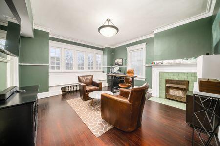 1349 E Broad St, Columbus, OH 43205 - sitting room featuring a fireplace, wood finished floors, and ornamental molding