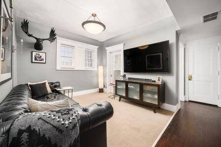 1349 E Broad St, Columbus, OH 43205 - living area featuring wood finished floors, baseboards, and visible vents