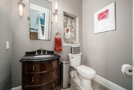 1349 E Broad St, Columbus, OH 43205 - bathroom featuring baseboards, toilet, and vanity