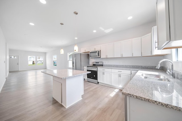 1559 Obetz Ave, Obetz, OH 43207 - kitchen featuring recessed lighting, a kitchen island, a sink, light wood finished floors, and appliances with stainless steel finishes