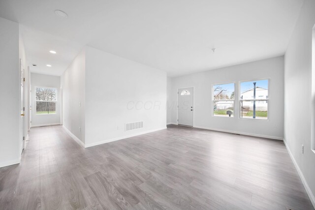 1559 Obetz Ave, Obetz, OH 43207 - unfurnished living room featuring baseboards, visible vents, wood finished floors, and recessed lighting