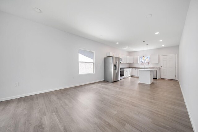 1559 Obetz Ave, Obetz, OH 43207 - unfurnished living room featuring baseboards, recessed lighting, and light wood-style floors
