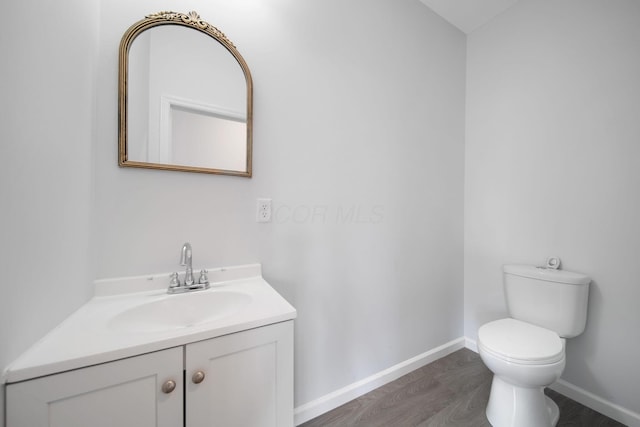 1559 Obetz Ave, Obetz, OH 43207 - bathroom with baseboards, toilet, vanity, and wood finished floors