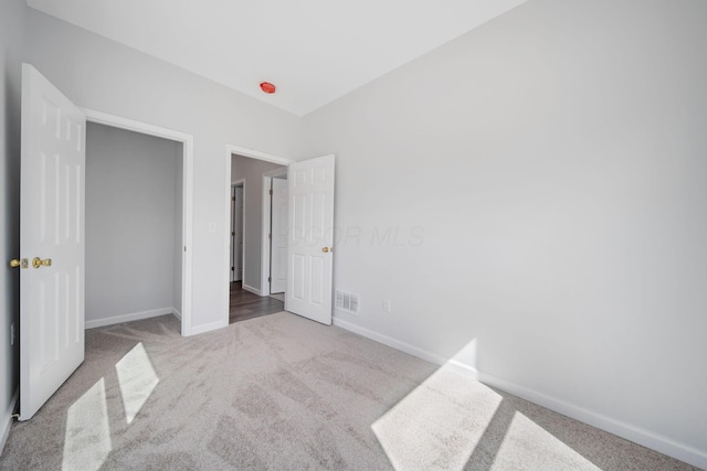 1559 Obetz Ave, Obetz, OH 43207 - unfurnished bedroom featuring baseboards, visible vents, and carpet flooring