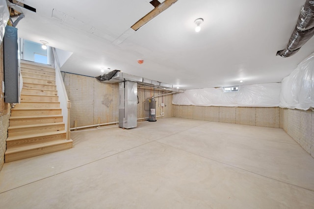 1559 Obetz Ave, Obetz, OH 43207 - unfinished below grade area featuring heating unit, electric water heater, and stairs