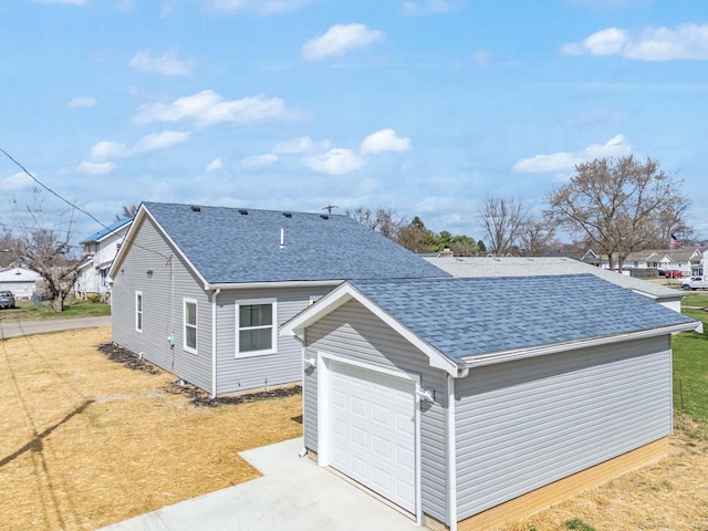 1559 Obetz Ave, Obetz, OH 43207 - exterior space featuring a front yard, concrete driveway, roof with shingles, and an attached garage