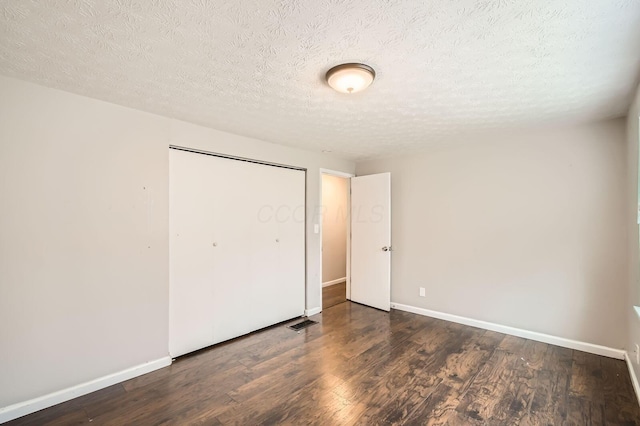 3484 Sweetday St, Columbus, OH 43224 - unfurnished bedroom featuring baseboards, wood finished floors, a closet, and a textured ceiling