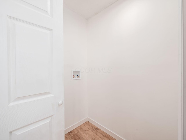 laundry room featuring light wood finished floors, baseboards, laundry area, and hookup for a washing machine
