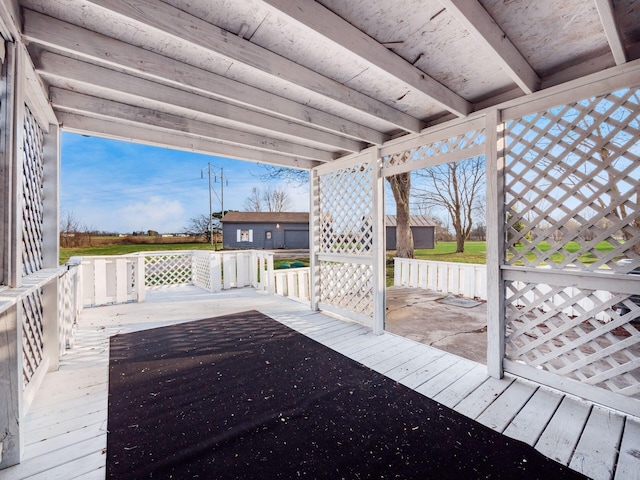 wooden terrace featuring an outdoor structure