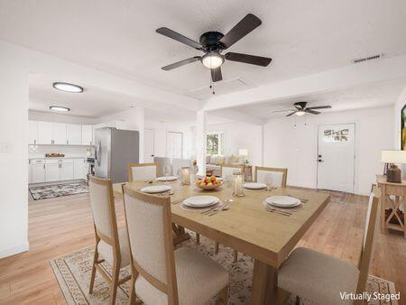 dining room featuring a ceiling fan, light wood-style flooring, and visible vents