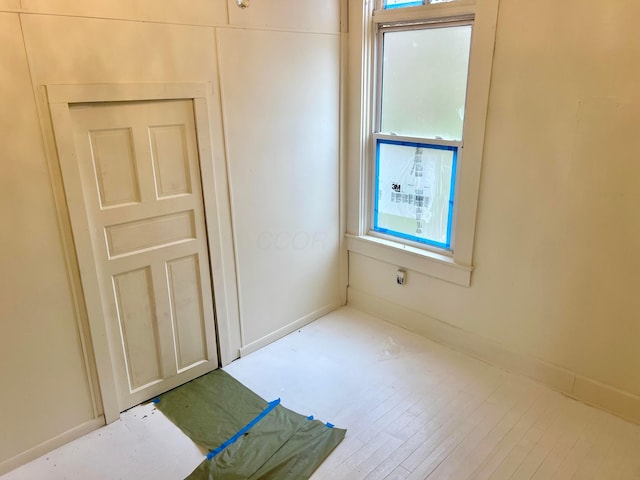 spare room featuring wood finished floors and baseboards