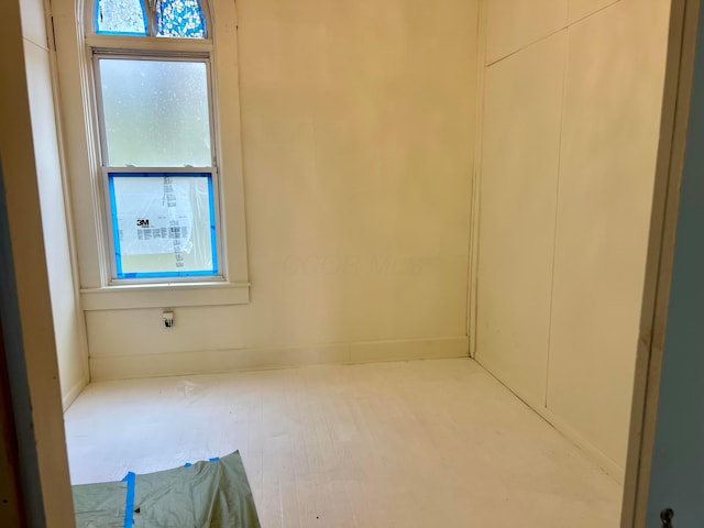 empty room featuring wood finished floors and a healthy amount of sunlight