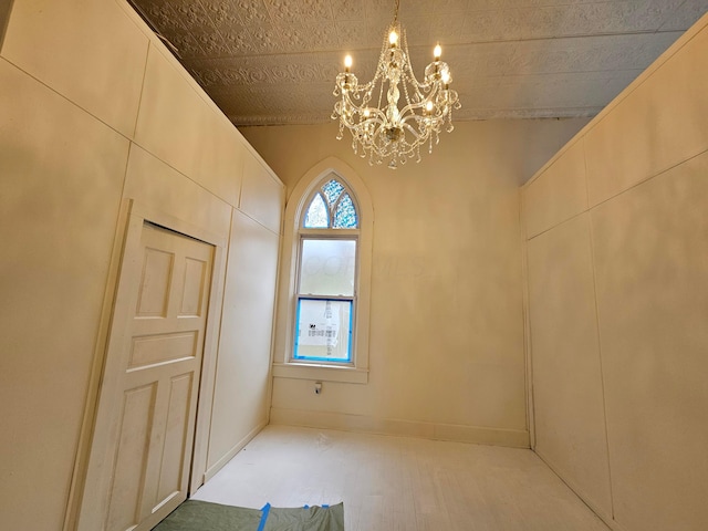 interior space featuring a chandelier and baseboards