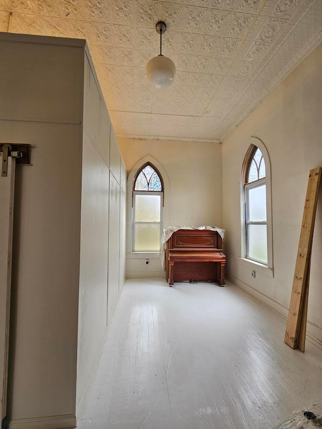 unfurnished bedroom with wood-type flooring and an ornate ceiling