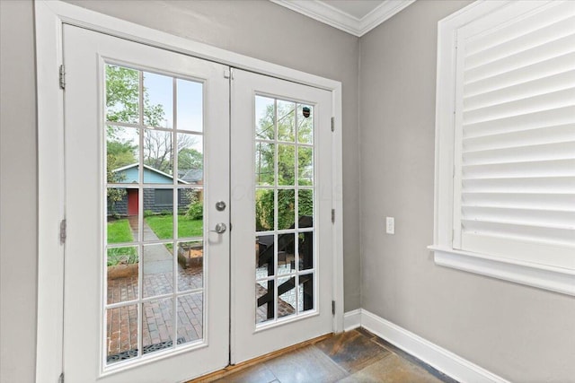 doorway with crown molding, baseboards, and french doors