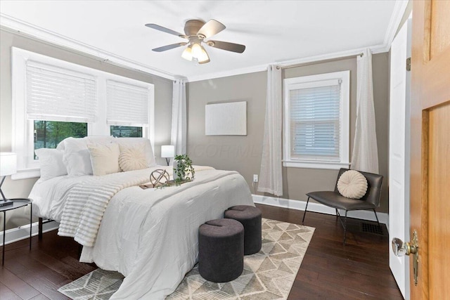 bedroom with crown molding, baseboards, ceiling fan, and hardwood / wood-style floors
