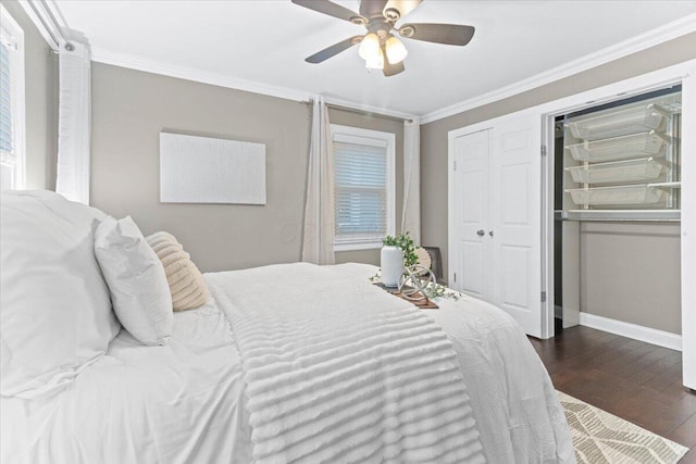 bedroom featuring a ceiling fan, baseboards, dark wood finished floors, and ornamental molding