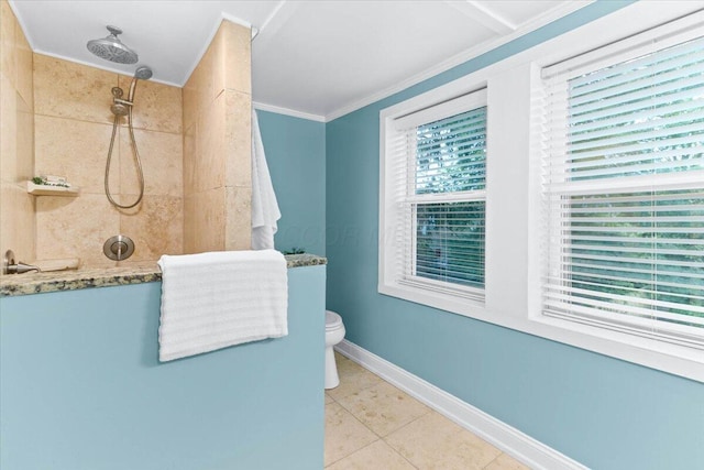 bathroom with crown molding, tile patterned floors, baseboards, and tiled shower