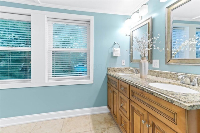 full bath featuring crown molding, a sink, baseboards, and double vanity