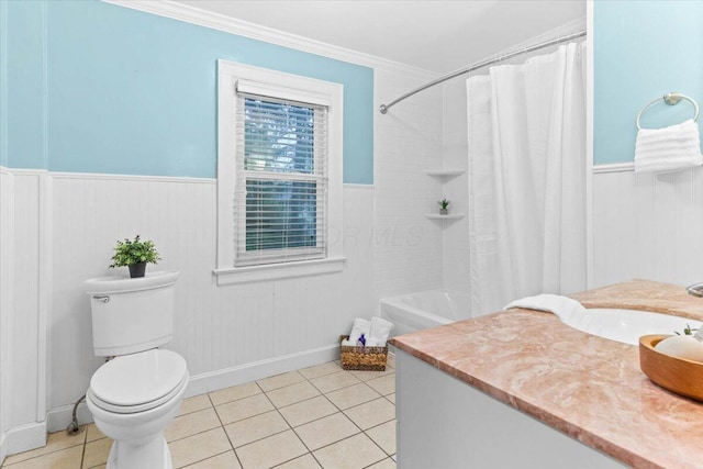 full bathroom with toilet, ornamental molding, tile patterned flooring, and a wainscoted wall