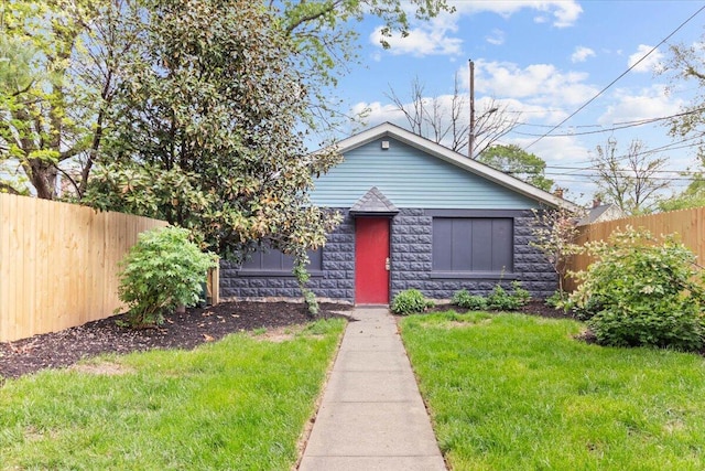 bungalow featuring a front lawn, fence, and stone siding