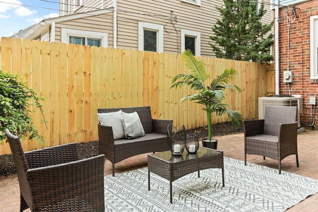 view of patio / terrace with central air condition unit, outdoor lounge area, and fence