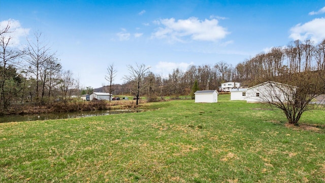 view of yard featuring a storage unit and an outdoor structure