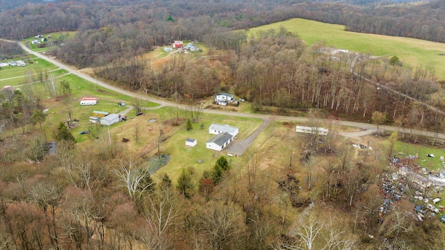 bird's eye view featuring a wooded view and a rural view