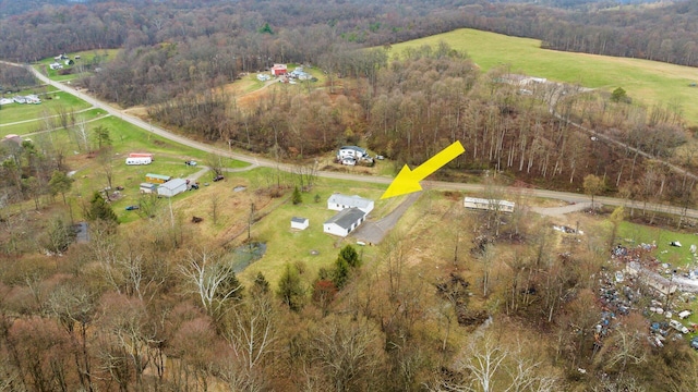 aerial view featuring a wooded view and a rural view