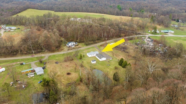 birds eye view of property with a forest view and a rural view