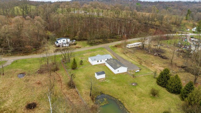birds eye view of property with a wooded view