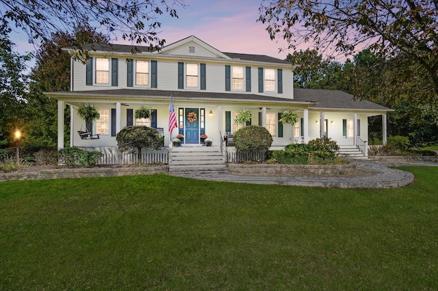 view of front of home featuring a porch and a yard