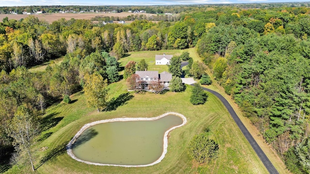 bird's eye view with a wooded view