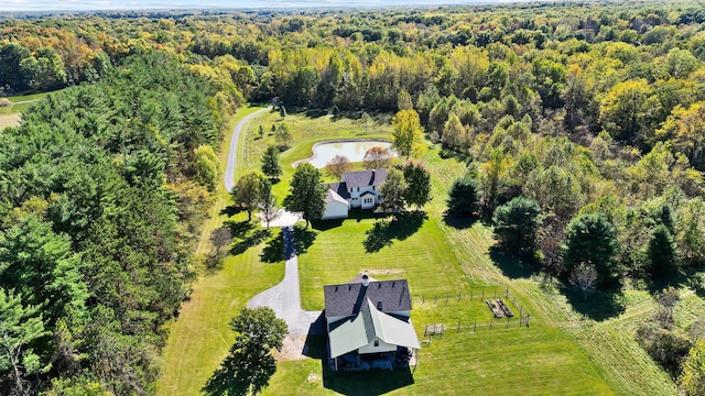 drone / aerial view featuring a forest view