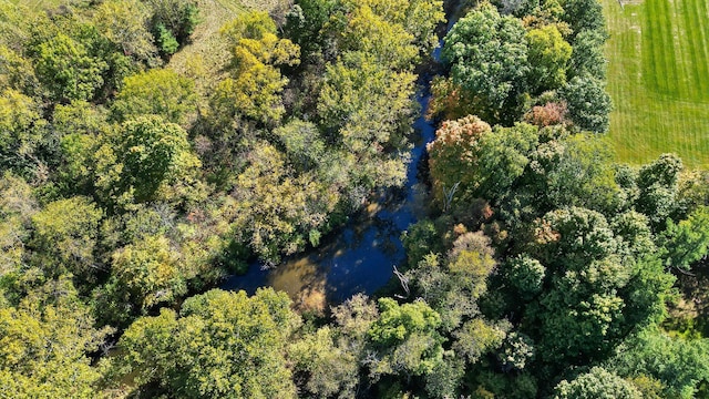 birds eye view of property with a view of trees