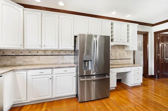 kitchen with white cabinetry, stainless steel fridge with ice dispenser, and open shelves