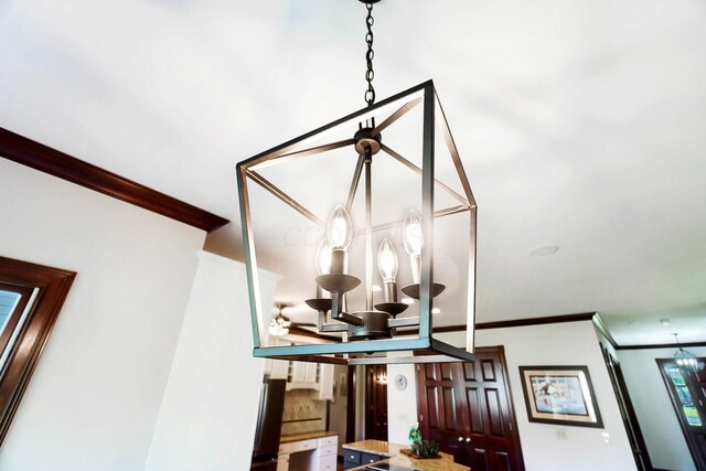 interior details with crown molding and a notable chandelier