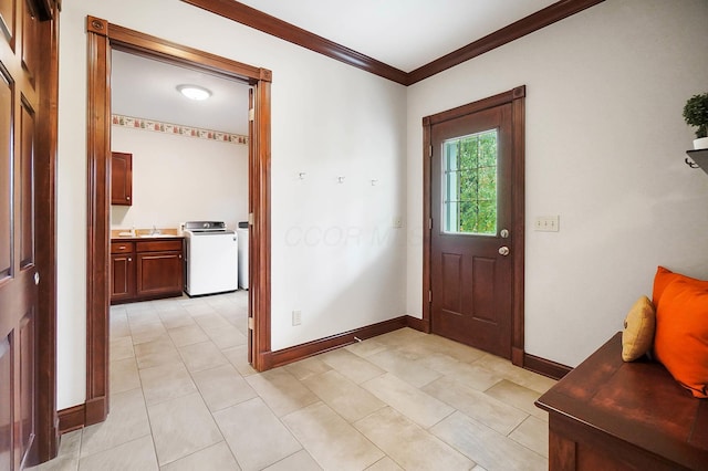 entrance foyer with baseboards, light tile patterned floors, washer / clothes dryer, and crown molding