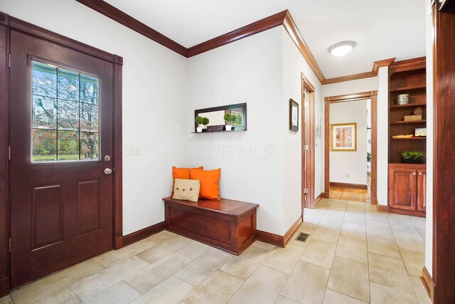 foyer with baseboards, visible vents, crown molding, and light tile patterned floors